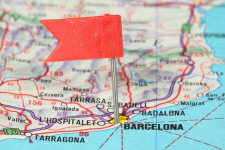 Barcelona - famous city in Spain. Red flag pin on an old map showing travel destination.の写真素材