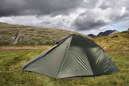 Tent in Lonsoraefi - desolate hiking area in Iceland. Summer camping. Stormclouds - overcast sky.の写真素材