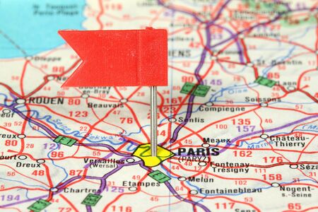 Paris - famous city in France. Red flag pin on an old map showing travel destination.の写真素材