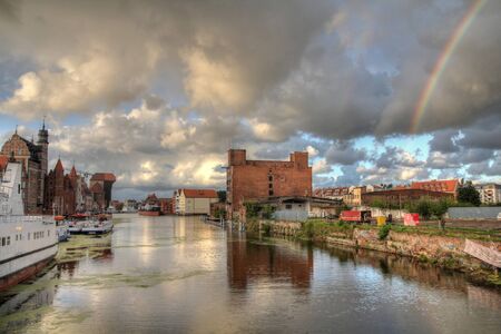 Poland - Gdansk city (also know nas Danzig) in Pomerania region. Old town view with Motlawa river and rainbow in HDR.の写真素材