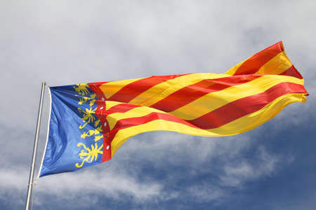 Flag of Comunidad Valenciana, region in Spain. Moving in the wind.の写真素材