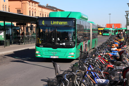 MALMO - MARCH 8: MAN bus and bicycles on March 8, 2011 in Malmo, Sweden. In 2009 MAN delivered 6,232 buses to customers. Cycling is major competition for public transport in Malmo, which is a bicycle friendly city.のeditorial素材