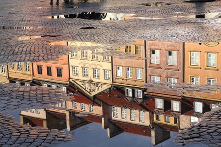 Warsaw, Poland. Old Town rain puddle reflection - tenements at the main square. の写真素材