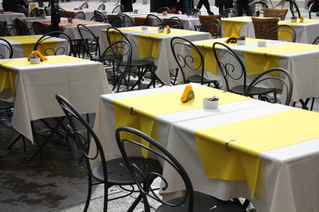 Outdoor city restaurant tables. Parma, Italy - Emilia-Romagna region.のeditorial素材