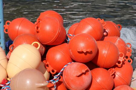 Orange plastic buoys for fishing nets. Fishing industry in Croatia.の写真素材