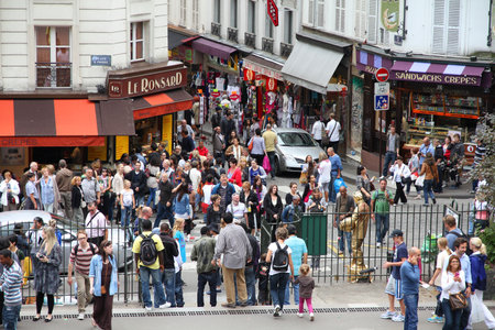 PARIS - JULY 22: Tourists stroll in Montmartre district on July 22, 2011 in Paris, France. Monmartre area is popular among tourists in Paris, the most visited city worldwide.のeditorial素材