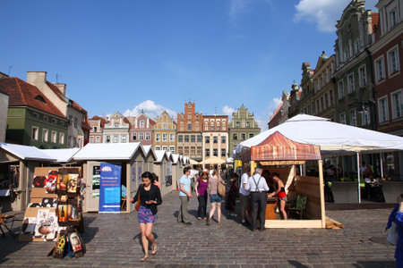 POZNAN, POLAND - JUNE 6: Tourists shop at the main square on June 6, 2011 in Poznan, Poland. With 1.7m visitors (2006 data) Poznan is the 3rd most visited city in Poland.のeditorial素材