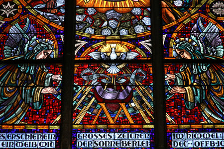 Vienna, Austria - colorful stained glass in Votivkirche (Votive Church). Holy Spirit depicted as a dove.のeditorial素材