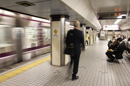 OSAKA, JAPAN - APRIL 27: People wait at Osaka Subway station on April 27, 2012 in Osaka, Japan. Osaka Subway is 12th busiest metro system worldwide with 837 million annual ridership (2010).のeditorial素材