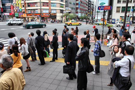 TOKYO - MAY 8: Commuters hurry on May 8, 2012 in Shinjuku district, Tokyo. Shinjuku is one of the busiest districts of Tokyo, with many international corporate headquarters located here.のeditorial素材