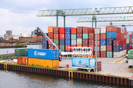 DORTMUND, GERMANY - JULY 16: Containers are loaded in Dortmund Port on July 16, 2012 in Germany. It...