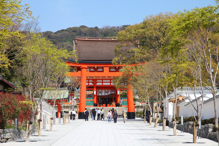 KYOTO, JAPAN - APRIL 18: Tourists visit Fushimi Inari shrine on April 18, 2012 in Kyoto, Japan. Old Kyoto is a UNESCO World Heritage site and was visited by almost 1 million foreign tourists in 2010.のeditorial素材