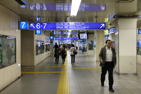 KYOTO, JAPAN - APRIL 18: Travelers hurry at Kyoto Station on April 18, 2012 in Kyoto, Japan. It is Japan's 2nd biggest train station building. The building is recent, but station existed here since 1877.のeditorial素材