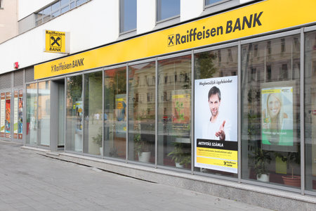 PECS, HUNGARY - AUGUST 11: Reiffeisen Bank branch on August 11, 2012 in Pecs, Hungary. Reiffeisen Group exists since 1927, employs 55,400 people and had 1,2 billion EUR net income in 2011.のeditorial素材