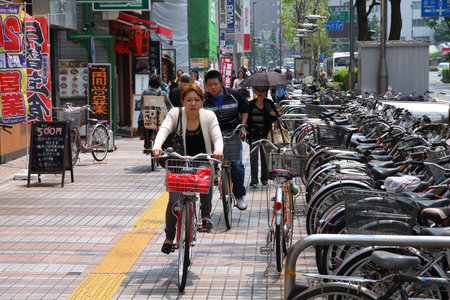 KAWASAKI, JAPAN - MAY 10: People ride bicycles on May 10, 2012 in Kawasaki, Japan. Cycling is one of most popular transport modes in Kawasaki, city inhabited by 1.44 million people.のeditorial素材