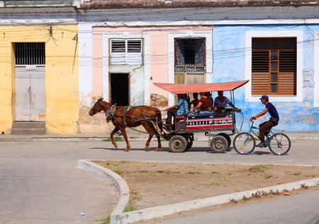 SANCTI SPIRITUS, CUBA - FEBRUARY 6: Cubans ride horse-drawn cart on February 6, 2011 in Sancti Spiritus, Cuba. Cuba has one of lowest vehicle per capita rates in the world (38 per 1000 citizens in 2008).のeditorial素材