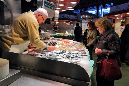 BARCELONA, SPAIN - NOVEMBER 6: People visit Boqueria market on November 6, 2012 in Barcelona, Spain. Tripadvisor says it is best shopping destination in Barcelona, the most visited city in Spain.のeditorial素材