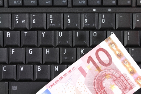 Online business - notebook keyboard and Euro currency moneyの写真素材