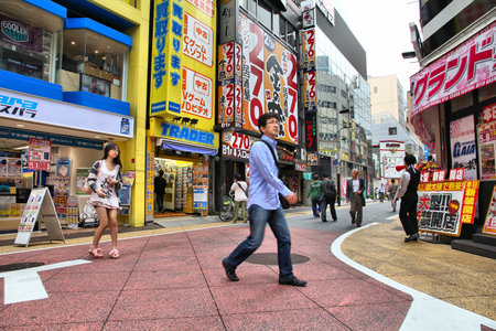 TOKYO - MAY 8: Shoppers walk on May 8, 2012 in Shinjuku district, Tokyo. Shinjuku is one of the busiest districts of Tokyo, with many international corporate headquarters located here.のeditorial素材