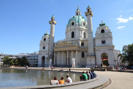 VIENNA - SEPTEMBER 6: Tourists rest in front of St. Charles Church on September 6, 2011 in Vienna. As of 2008, Vienna was the 20th most visited city worldwide (by international visitors).のeditorial素材