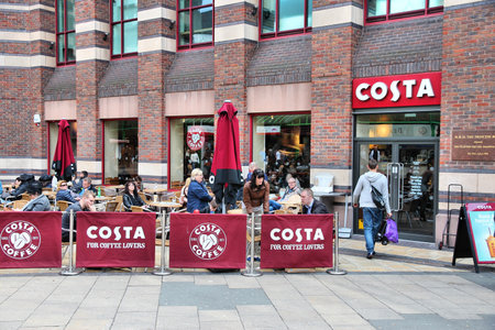 LIVERPOOL, UK - APRIL 20: People sit at Costa Coffee on April 20, 2013 in Liverpool, UK. Costa Coffee has 1,700 stores in 28 countries. 1,375 cafes in the UK attract 4m customers a week.のeditorial素材