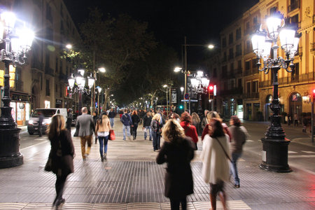BARCELONA, SPAIN - NOVEMBER 5: People walk famous Rambla boulevard on November 5, 2012 in Barcelona,...