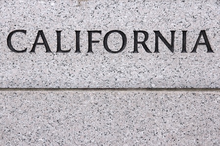 California - US state name carved in grey granite stoneの写真素材