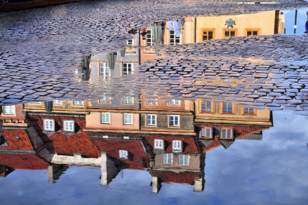 Warsaw, Poland. Old Town rain puddle reflection - tenements at the main square. の写真素材