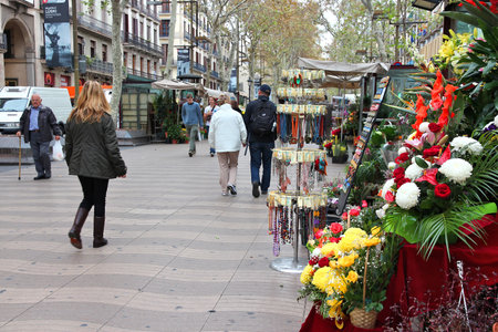 BARCELONA, SPAIN - NOVEMBER 6: Tourists walk famous Rambla street on November 6, 2012 in Barcelona,...