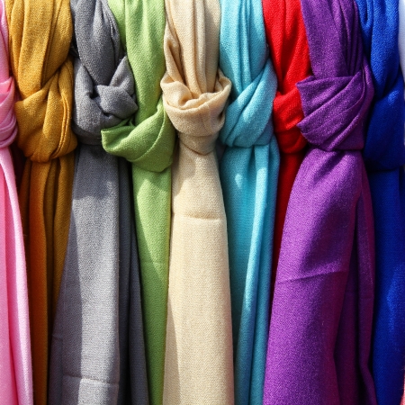Colorful scarves at a market in Italy. Colors of textiles. Square composition.