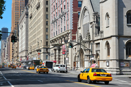 NEW YORK, USA - JULY 6, 2013: People ride yellow taxi at Central Park West in New York. As of 2012...