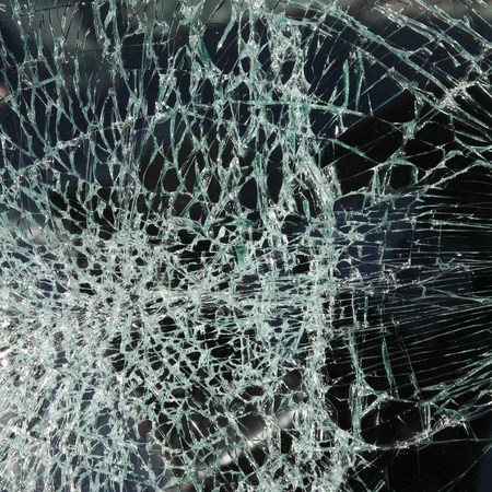 Broken car windshield made of laminated glass. Square composition.