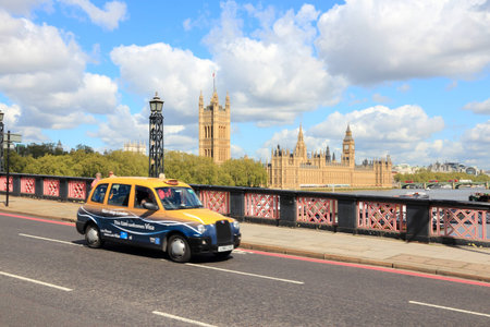 LONDON, UK - MAY 13, 2012: Taxi cab drives in London. As of 2012, there were 24,000 licensed taxi cabs in London.のeditorial素材