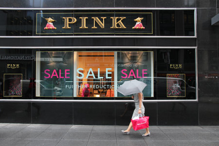NEW YORK, USA - JULY 1, 2013: Shopper walks by Thomas Pink store at 6th Avenue in New York. Thomas Pink luxury fashion company is part of famous LVMH Group.のeditorial素材