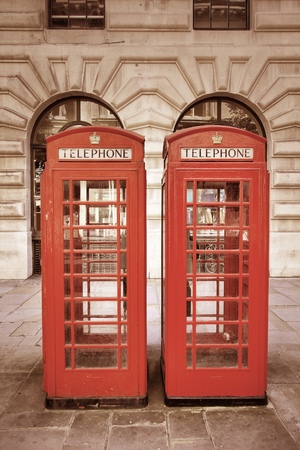 London, United Kingdom - red telephone booths. Phone boxes. Cross processing color tone - filtered retro style.の写真素材