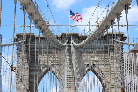New York City, United States - famous Brooklyn Bridge with US flagの写真素材
