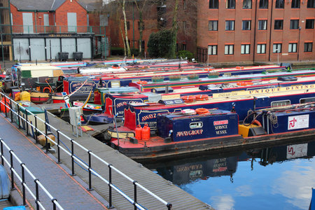 BIRMINGHAM, UK - APRIL 19, 2013: Narrowboats moored at Gas Street Basin in Birmingham, UK. Birmingham is the 2nd most populous British city. It has rich waterway and boat culture.のeditorial素材