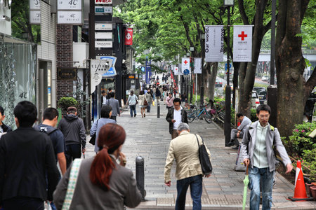 TOKYO, JAPAN - MAY 9, 2012: People shop in Omotesando district in Tokyo. Omote-sando is considered...