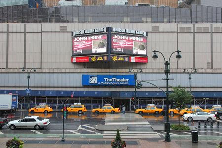 NEW YORK, USA - JULY 1, 2013: People walk by rainy Madison Square Garden in New York. MSG is one of most popular multi-purpose indoor arenas in NY. It dates back to 1964.のeditorial素材