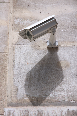 Surveillance camera in the city - electronic security technology.