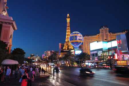 LAS VEGAS, USA - APRIL 14, 2014: People visit the famous Strip in Las Vegas. 15 of 25 largest hotels in the world are located at the strip with more than 60 thousand rooms.のeditorial素材