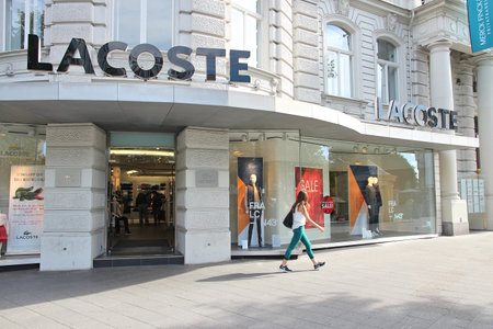 BERLIN, GERMANY - AUGUST 27, 2014: Person walks by Lacoste store at (Ku'Damm) Avenue in Berlin....