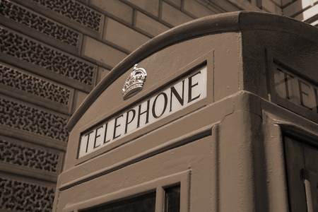 London, United Kingdom - red telephone box close-up. Sepia tone - filtered retro style monochrome photo.の写真素材