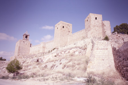 Antequera in Andalusia region of Spain. Alcazaba castle in typical Spanish town. Cross processed color tone - retro image filtered style.のeditorial素材