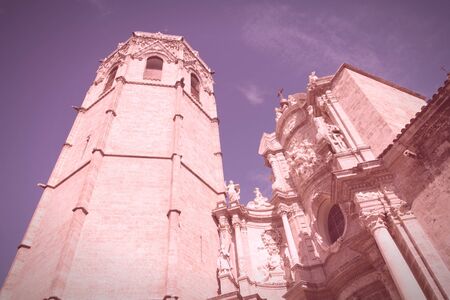 Valencia, Spain. Micalet tower, part of famous Cathedral. Cross processed color tone - retro image filtered style.の写真素材
