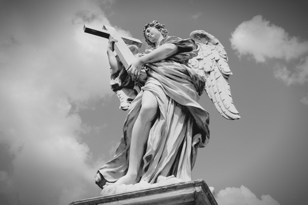 Rome, Italy. Angel statue at Ponte Sant' Angelo bridge. Baroque sculpture by Ercole Ferrata. Black and white retro style - monochrome color tone.の写真素材