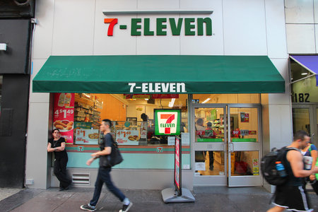 NEW YORK, USA - JULY 3, 2013: People walk past 7-Eleven convenience store in New York. 7-Eleven is...