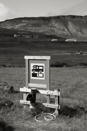 RV camping sewage dump station at a campground in Iceland. Focus on the sign. Black and white monochrome tone.の写真素材