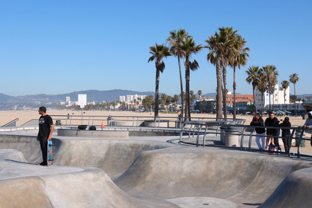 VENICE, UNITED STATES - APRIL 6, 2014: People visit skate park at Venice Beach, California. Venice Beach is one of most popular beaches of LA County. 9.8 million people live in LA County.のeditorial素材
