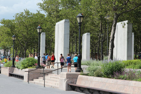 NEW YORK, USA - JULY 4, 2013: People walk in Battery Park in New York. Almost 19 million people live in New York City metropolitan area.のeditorial素材